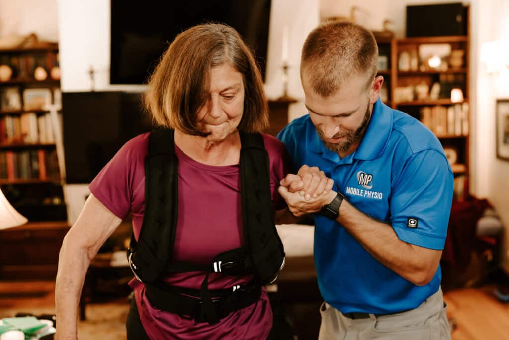 In-Home Physical Therapist helping with loss of balance in elderly - Dr Charles helping patient walk